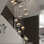 Серия подвесных светильников с LED-источниками света в полусферических рассеивателях с эффектом льда внутри шарообразных плафонов из тонированного стекла MAYER ORB L13 от ImperiumLoft