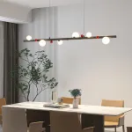 Подвесной рядный светильник с чередующимися белыми шарообразными плафонами и декоративными шариками красного цвета REIK LONG WHITE от ImperiumLoft Подвесной рядный светильник с чередующимися белыми шарообразными плафонами и декоративными шариками красного цвета REIK LONG WHITE от ImperiumLoft